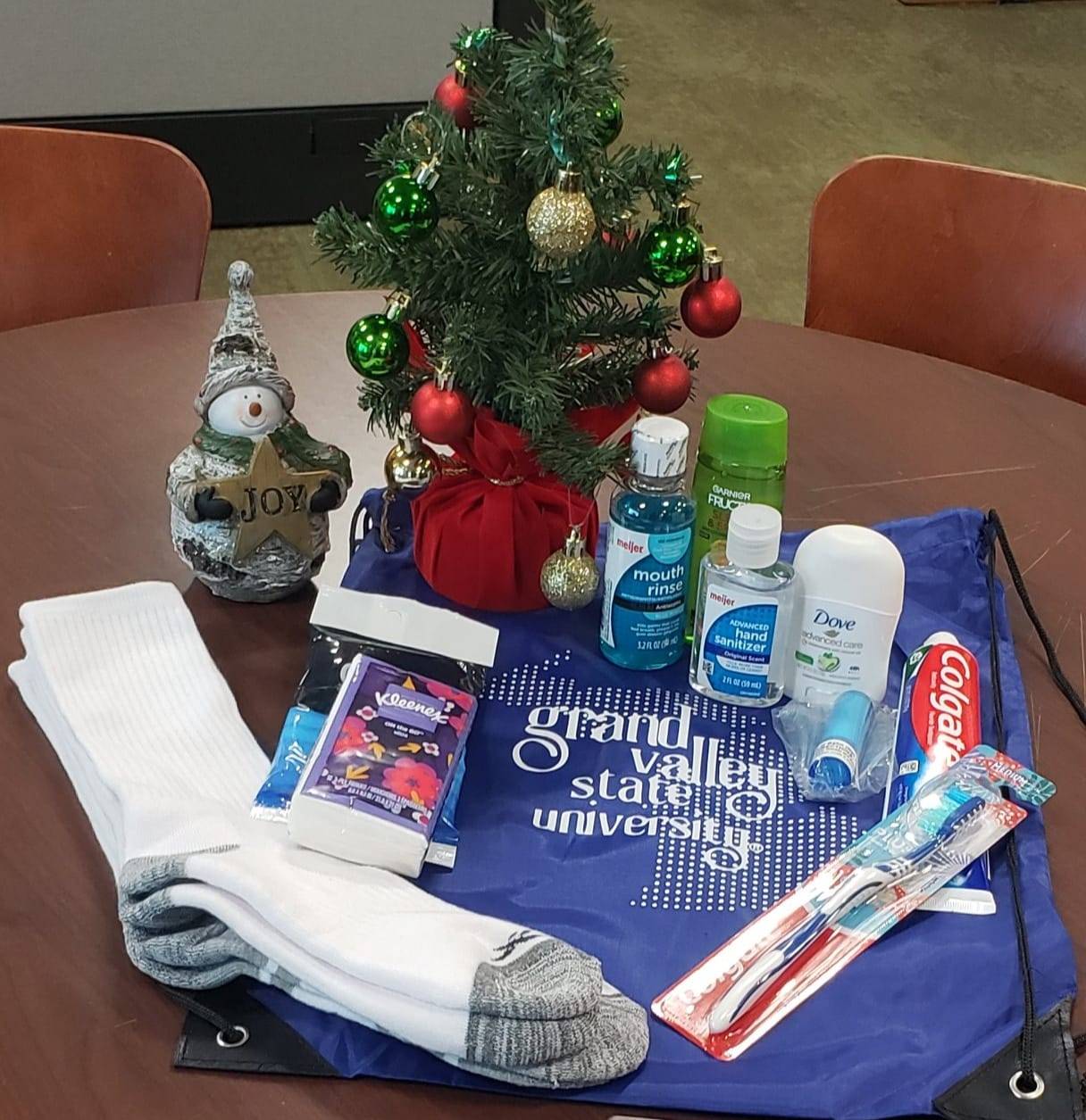 Small christmas tree and toiletries on a table.